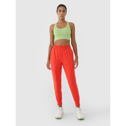 Damskie spodnie treningowe 4F 4FRSS25TFTRF0789 - czerwone XL Sportstylestory.com