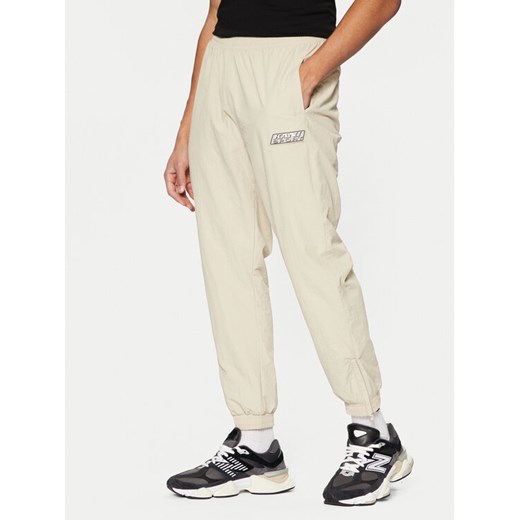Karl Kani Spodnie dresowe Sport Patch Essential 60030075 Beżowy Relaxed Fit ze sklepu MODIVO w kategorii Spodnie męskie - zdjęcie 181127180