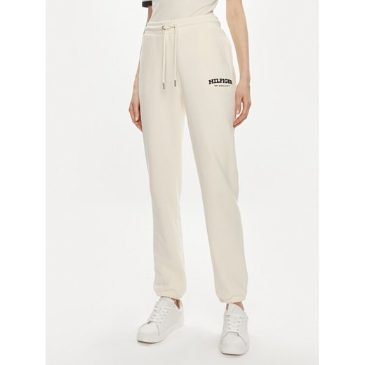 Tommy Hilfiger Spodnie dresowe Monotype WW0WW41572 Beżowy Regular Fit ze sklepu MODIVO w kategorii Spodnie damskie - zdjęcie 182601773