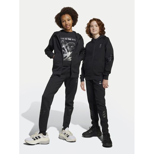 adidas Spodnie dresowe Star Wars The Mandalorian™ JF3635 Czarny Regular Fit ze sklepu MODIVO w kategorii Spodnie chłopięce - zdjęcie 182605091