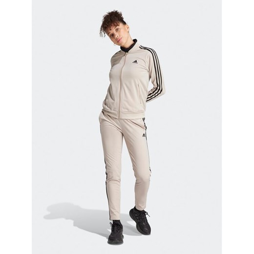 adidas Dres Essentials 3-Stripes IJ8786 Beżowy Slim Fit ze sklepu MODIVO w kategorii Dresy damskie - zdjęcie 182606130
