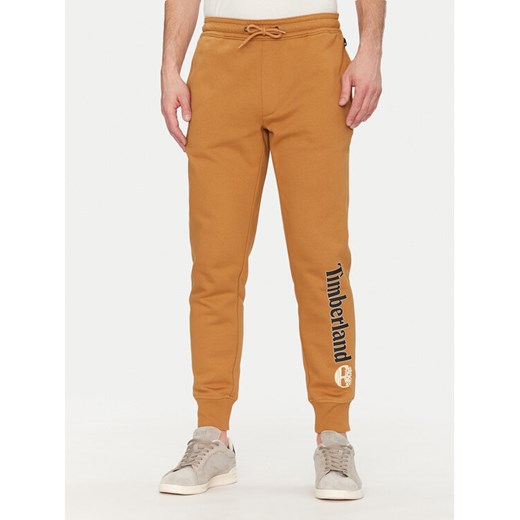 Timberland Spodnie dresowe TB0A5YFB Beżowy Regular Fit ze sklepu MODIVO w kategorii Spodnie męskie - zdjęcie 182608713