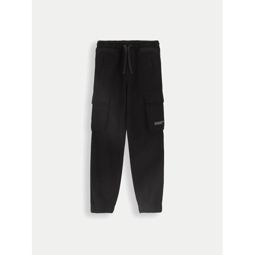 Coccodrillo Spodnie materiałowe ZC4119101DBJ Czarny Slim Fit ze sklepu MODIVO w kategorii Spodnie dziewczęce - zdjęcie 182608744