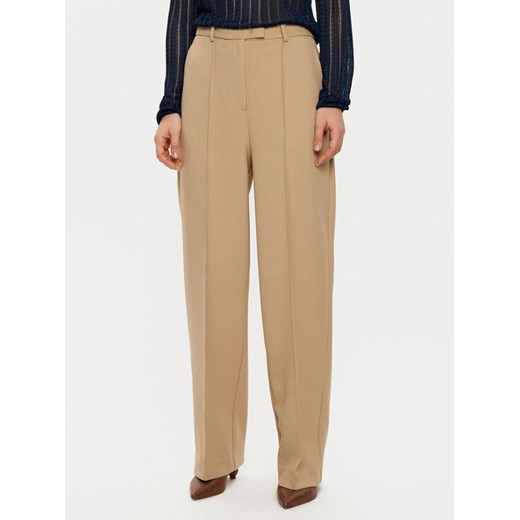 Tommy Hilfiger Spodnie materiałowe WW0WW43875 Beżowy Regular Fit ze sklepu MODIVO w kategorii Spodnie damskie - zdjęcie 182619372