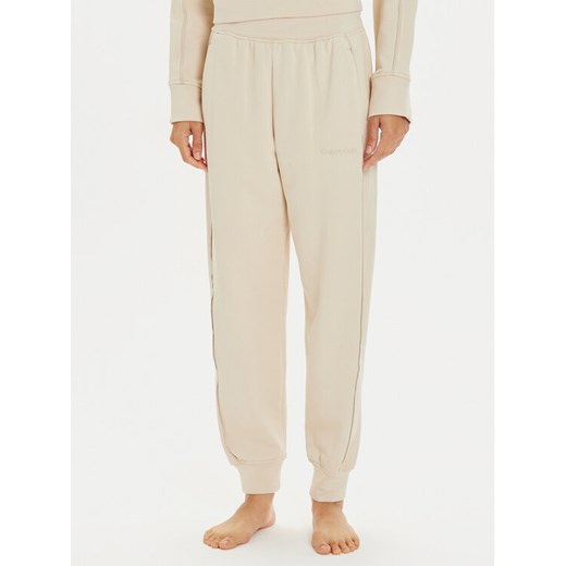 Calvin Klein Underwear Spodnie dresowe 000QS7262E Beżowy Regular Fit ze sklepu MODIVO w kategorii Spodnie damskie - zdjęcie 182621252