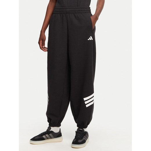 adidas Spodnie dresowe Future Icons 3-Stripes Parachute JE0141 Czarny Loose Fit ze sklepu MODIVO w kategorii Spodnie damskie - zdjęcie 182624111