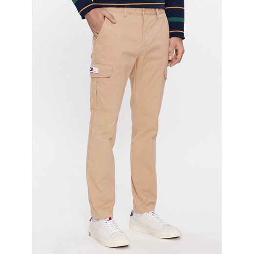 Tommy Jeans Spodnie materiałowe Austin DM0DM18341 Beżowy Slim Fit ze sklepu MODIVO w kategorii Spodnie męskie - zdjęcie 182626002