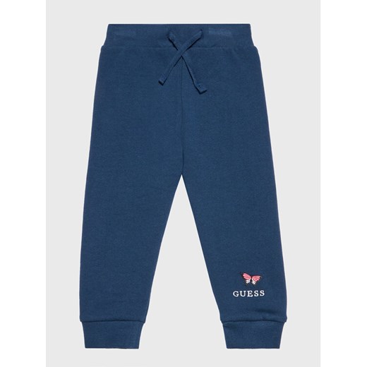 Guess Spodnie dresowe K2BQ13 KAD70 Granatowy Regular Fit ze sklepu MODIVO w kategorii Spodnie dziewczęce - zdjęcie 182626052