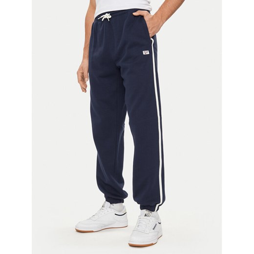 Reebok Spodnie dresowe Court Sport 100075479 Granatowy Relaxed Fit ze sklepu MODIVO w kategorii Spodnie męskie - zdjęcie 182627192