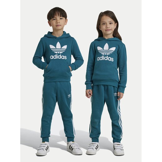 adidas Dres adicolor IY4789 Turkusowy Regular Fit ze sklepu MODIVO w kategorii Dresy chłopięce - zdjęcie 182632870