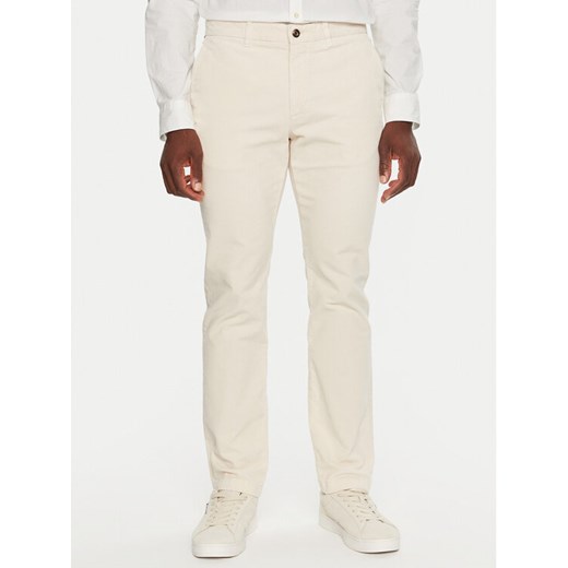 Tommy Hilfiger Spodnie materiałowe MW0MW32932 Écru Regular Fit ze sklepu MODIVO w kategorii Spodnie męskie - zdjęcie 182637302