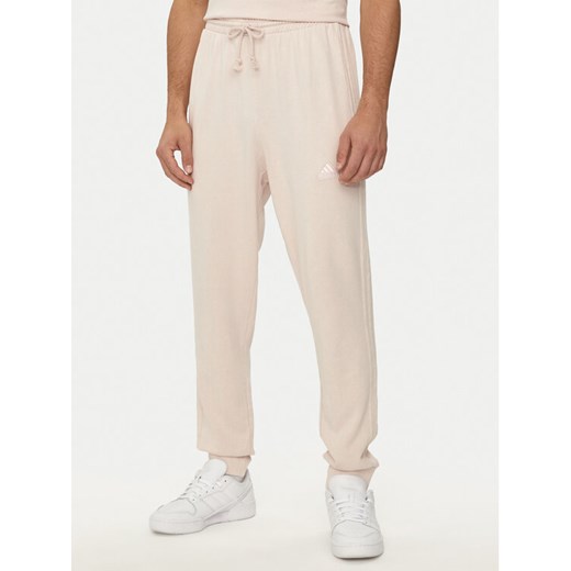 adidas Spodnie dresowe ALL SZN 3-Stripes IR5201 Różowy Regular Fit ze sklepu MODIVO w kategorii Spodnie męskie - zdjęcie 182637634