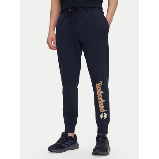 Timberland Spodnie dresowe TB0A5YFB Granatowy Regular Fit ze sklepu MODIVO w kategorii Spodnie męskie - zdjęcie 182640650