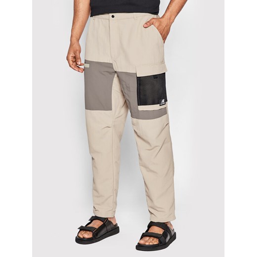 New Balance Spodnie materiałowe MP21502 Beżowy Relaxed Fit ze sklepu MODIVO w kategorii Spodnie męskie - zdjęcie 182646322