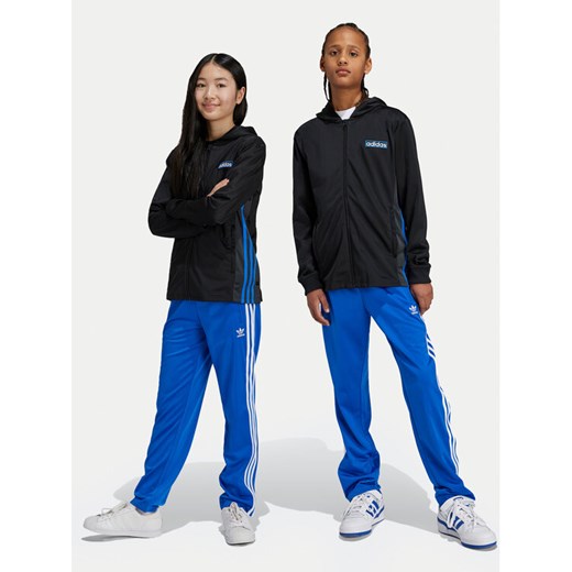 adidas Spodnie dresowe Firebird IY9803 Niebieski Regular Fit ze sklepu MODIVO w kategorii Spodnie chłopięce - zdjęcie 182648452