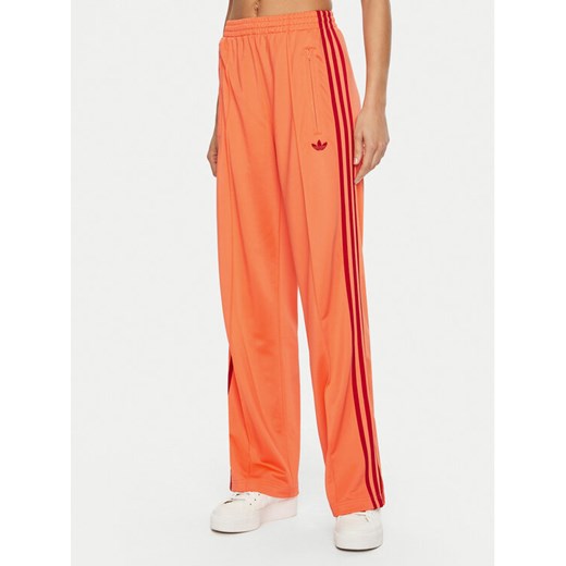 adidas Spodnie dresowe adicolor Classic Firebird JP2309 Pomarańczowy Loose Fit ze sklepu MODIVO w kategorii Spodnie damskie - zdjęcie 182649094