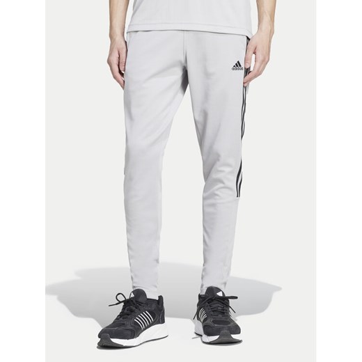 adidas Spodnie dresowe Tiro IY4288 Szary Regular Fit ze sklepu MODIVO w kategorii Spodnie męskie - zdjęcie 182654472