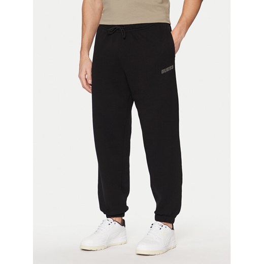 Guess Spodnie dresowe Z4YB00 KAIJ1 Czarny Relaxed Fit ze sklepu MODIVO w kategorii Spodnie męskie - zdjęcie 182655170