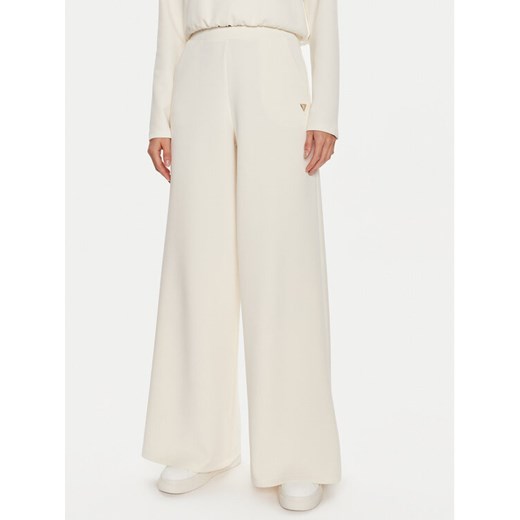 Guess Spodnie dresowe Olympe V4YB07 KCAY2 Beżowy Relaxed Fit - id: 0000303932800 - marki Guess - 182660621 Guess Spodnie dresowe Olympe V4YB07 KCAY2 Beżowy Relaxed Fit ze sklepu MODIVO w kategorii Spodnie damskie - zdjęcie 182660621