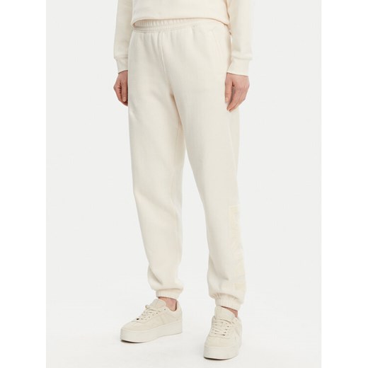 DKNY Spodnie dresowe DP5P3585 Beżowy Regular Fit ze sklepu MODIVO w kategorii Spodnie damskie - zdjęcie 182672112
