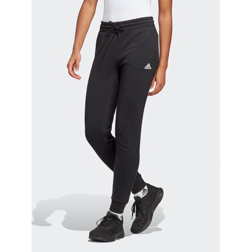 adidas Spodnie dresowe Essentials Linear French Terry Cuffed Joggers IC6868 Czarny Slim Fit ze sklepu MODIVO w kategorii Spodnie damskie - zdjęcie 182685101