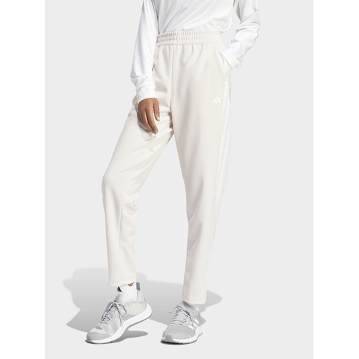 adidas Spodnie dresowe Train Essentials IS3969 Różowy Loose Fit ze sklepu MODIVO w kategorii Spodnie damskie - zdjęcie 182687504