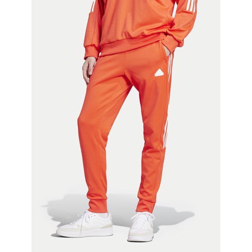 adidas Spodnie dresowe House of Tiro IW3581 Pomarańczowy Regular Fit ze sklepu MODIVO w kategorii Spodnie męskie - zdjęcie 182688323