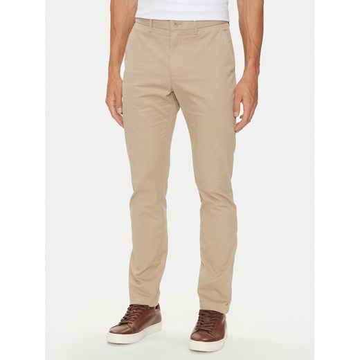 Tommy Hilfiger Chinosy Bleecker MW0MW26619 Beżowy Slim Fit ze sklepu MODIVO w kategorii Spodnie męskie - zdjęcie 182690481