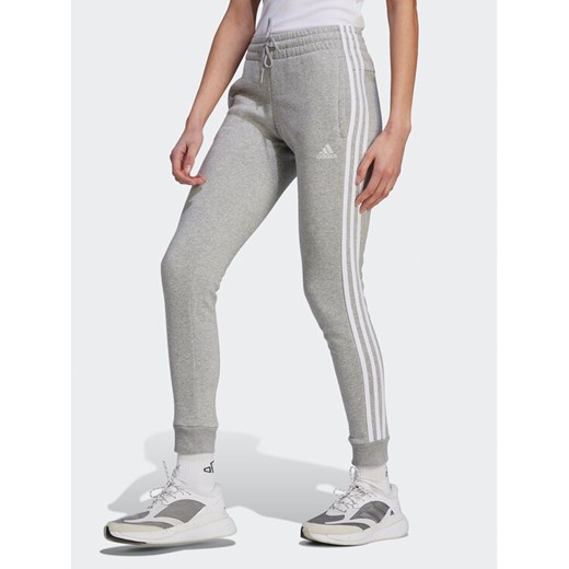adidas Spodnie dresowe Essentials 3-Stripes IL3282 Szary Slim Fit ze sklepu MODIVO w kategorii Spodnie damskie - zdjęcie 182692893