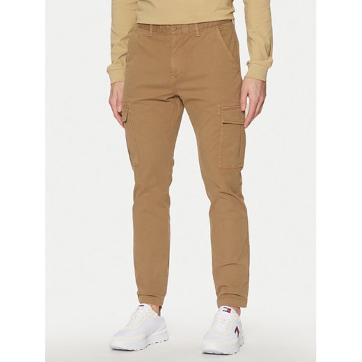 Tommy Jeans Spodnie materiałowe Austin DM0DM20281 Beżowy Regular Fit ze sklepu MODIVO w kategorii Spodnie męskie - zdjęcie 182700594