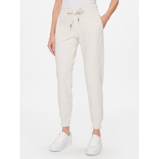 DKNY Sport Spodnie dresowe DP2P1917 Beżowy Classic Fit ze sklepu MODIVO w kategorii Spodnie damskie - zdjęcie 182701141
