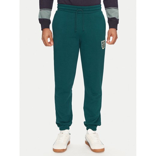 Puma Spodnie dresowe Sports Legacy Graphic 629631 Zielony Regular Fit ze sklepu MODIVO w kategorii Spodnie męskie - zdjęcie 182704030