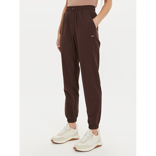 Athlecia Spodnie dresowe Hero W Track EA233336 Brązowy Regular Fit ze sklepu MODIVO w kategorii Spodnie damskie - zdjęcie 182704520