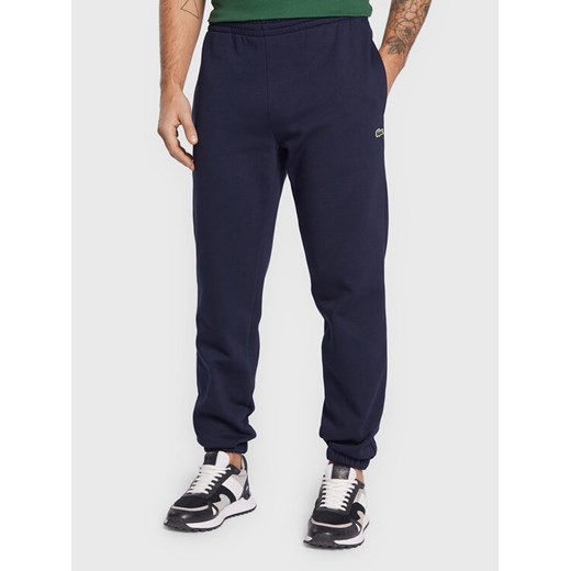 Lacoste Spodnie dresowe XH9610 Granatowy Regular Fit ze sklepu MODIVO w kategorii Spodnie męskie - zdjęcie 182706194