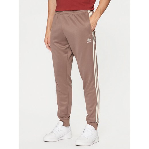 adidas Spodnie dresowe adicolor Classics SST JP2518 Beżowy Slim Fit ze sklepu MODIVO w kategorii Spodnie męskie - zdjęcie 182707261