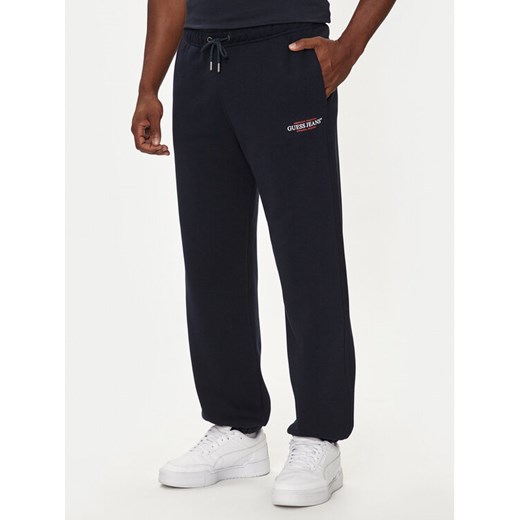 Guess Jeans Spodnie dresowe M4YB18 K9V31 Granatowy Regular Fit ze sklepu MODIVO w kategorii Spodnie męskie - zdjęcie 182718231