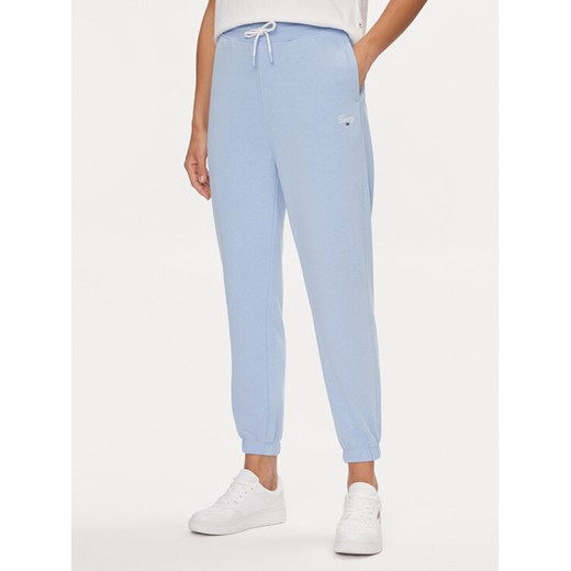 Tommy Jeans Spodnie dresowe Script DW0DW17771 Błękitny Relaxed Fit ze sklepu MODIVO w kategorii Spodnie damskie - zdjęcie 182719802