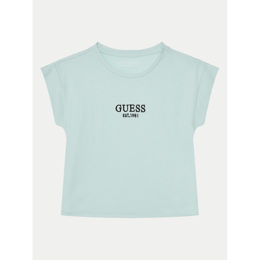 Guess T-Shirt J4BI34 J1314 Błękitny Boxy Fit ze sklepu MODIVO w kategorii Bluzki dziewczęce - zdjęcie 182727024