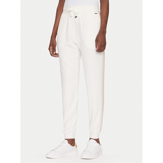 BOSS Spodnie dresowe Monogram 50535841 Écru Regular Fit ze sklepu MODIVO w kategorii Spodnie damskie - zdjęcie 182732550