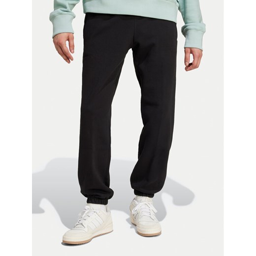 adidas Spodnie dresowe Premium Essentials IY2245 Czarny Loose Fit ze sklepu MODIVO w kategorii Spodnie męskie - zdjęcie 182736521