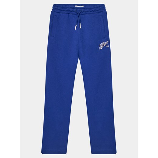 Tommy Hilfiger Spodnie dresowe Hilfiger Script Wide Sweatpant KG0KG07751 Niebieski Regular Fit ze sklepu MODIVO w kategorii Spodnie chłopięce - zdjęcie 182737112