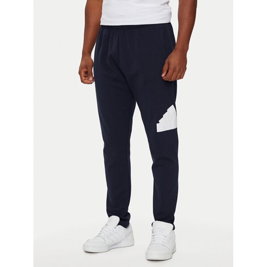 adidas Spodnie dresowe Future Icons Badge of Sport IW8584 Granatowy Regular Fit ze sklepu MODIVO w kategorii Spodnie męskie - zdjęcie 182747450