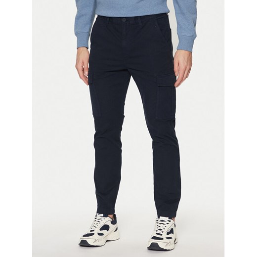 Tommy Jeans Spodnie materiałowe Austin DM0DM20281 Granatowy Regular Fit ze sklepu MODIVO w kategorii Spodnie męskie - zdjęcie 182749044