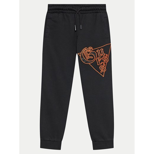 Guess Spodnie dresowe L4BQ11 KAD74 Czarny Regular Fit ze sklepu MODIVO w kategorii Spodnie chłopięce - zdjęcie 182750980