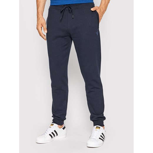Guess Spodnie dresowe Z2YB22 KAIJ1 Granatowy Regular Fit ze sklepu MODIVO w kategorii Spodnie męskie - zdjęcie 182752084