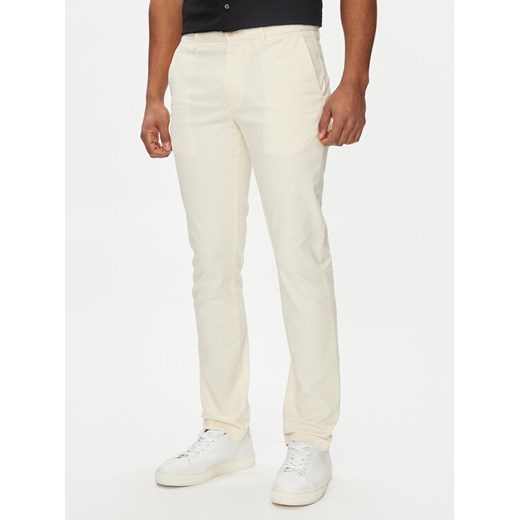 Tommy Hilfiger Chinosy Bleecker MW0MW26619 Écru Slim Fit ze sklepu MODIVO w kategorii Spodnie męskie - zdjęcie 182753533