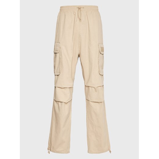 Karl Kani Spodnie materiałowe Rubber Signature 6002506 Beżowy Relaxed Fit ze sklepu MODIVO w kategorii Spodnie męskie - zdjęcie 182759790