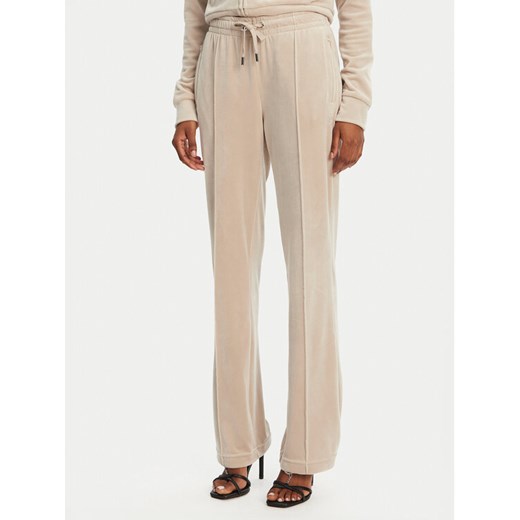 Juicy Couture Spodnie dresowe Tina JCAPW045 Beżowy Regular Fit ze sklepu MODIVO w kategorii Spodnie damskie - zdjęcie 182763164