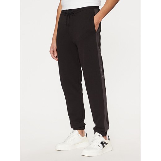 Calvin Klein Jeans Spodnie dresowe J30J327243 Czarny Regular Fit ze sklepu MODIVO w kategorii Spodnie męskie - zdjęcie 182766573