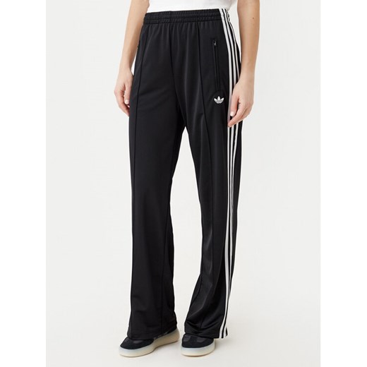 adidas Spodnie dresowe adicolor Classic Firebird JC8245 Czarny Loose Fit ze sklepu MODIVO w kategorii Spodnie damskie - zdjęcie 183593313